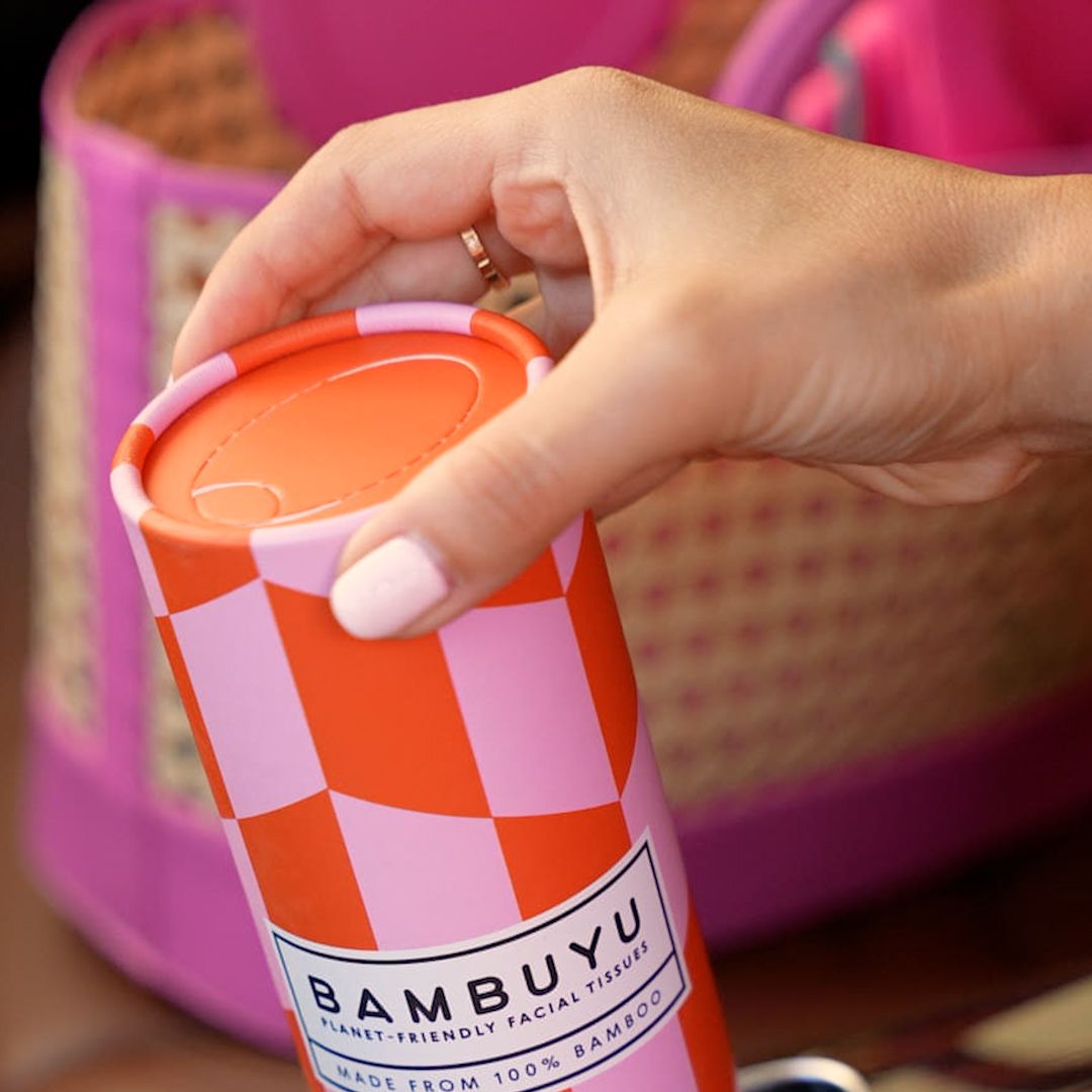 Hand holding a Bambuyu bamboo car tissue tube
