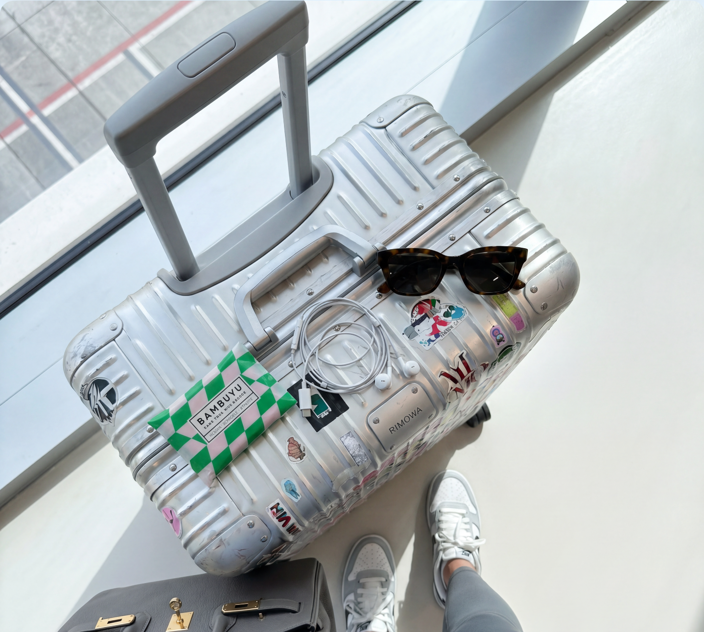 Bambuyu pocket tissue pack attached to a travel suitcase handle